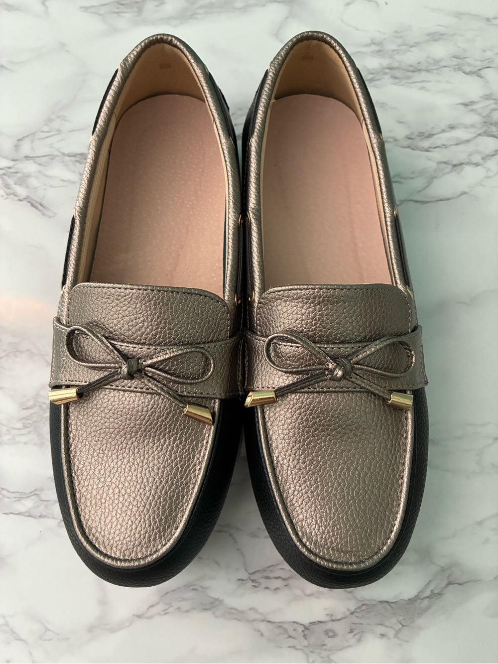 silver metallic and black leather loafers